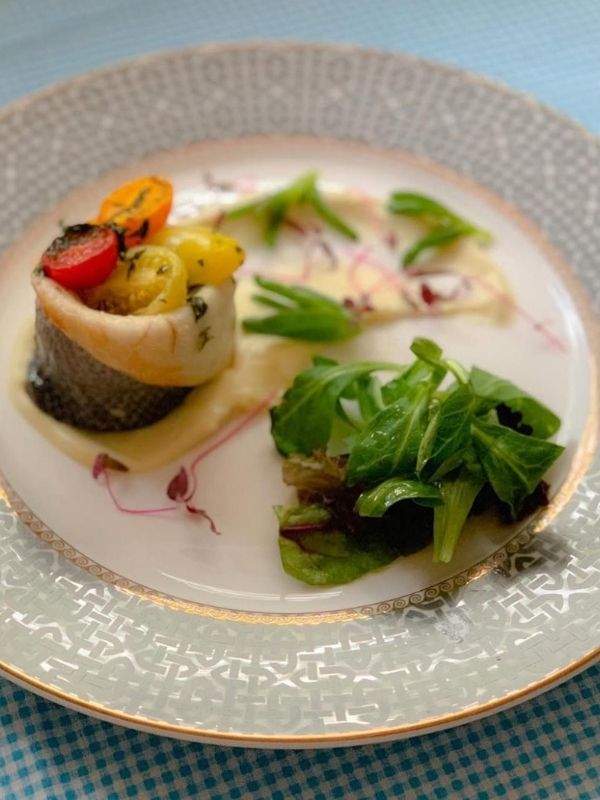 Sea bass parcel with heritage tomatoes, plated for a private dining menu in Nottingham