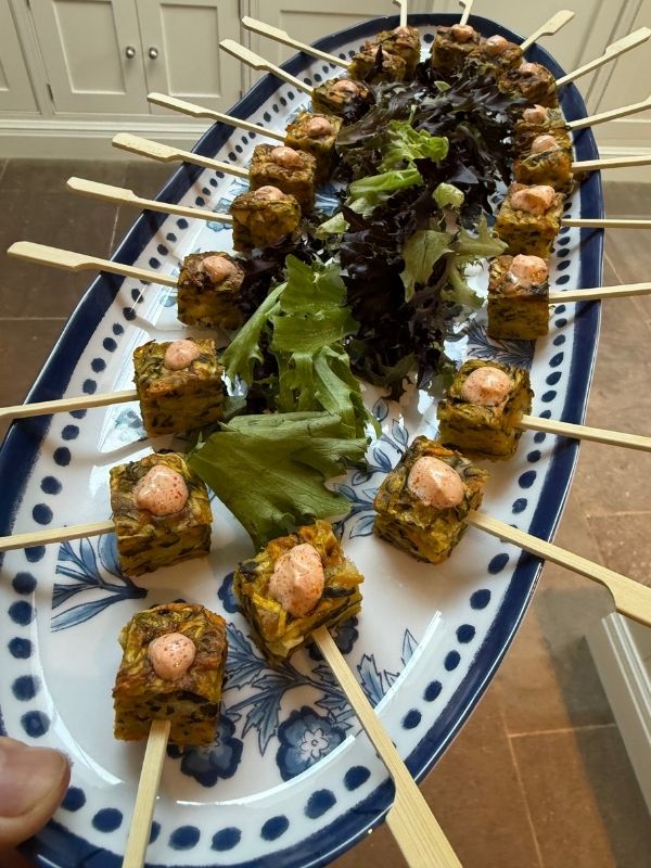 Bite-size vegetable fritter skewers served as canapés at a private chef event in Derbyshire